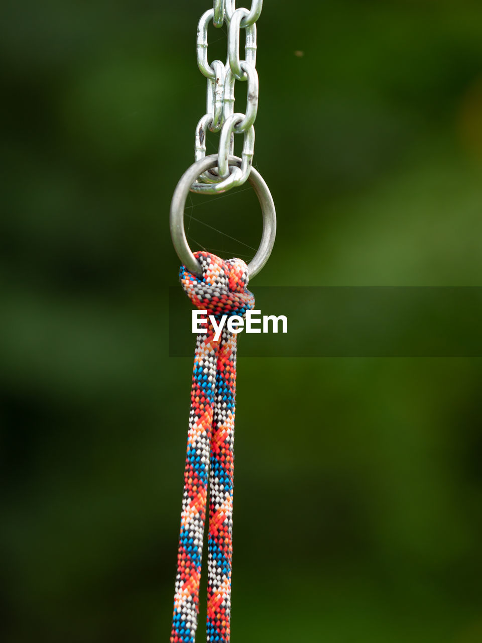 Connection of a steel chain and a solid hemp rope on a children's climbing frame.