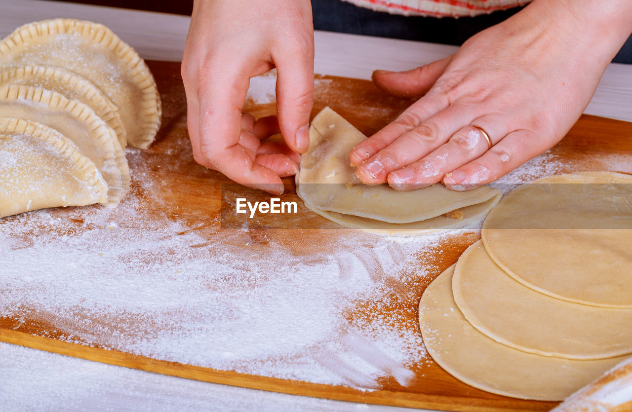 HIGH ANGLE VIEW OF PERSON PREPARING FOOD