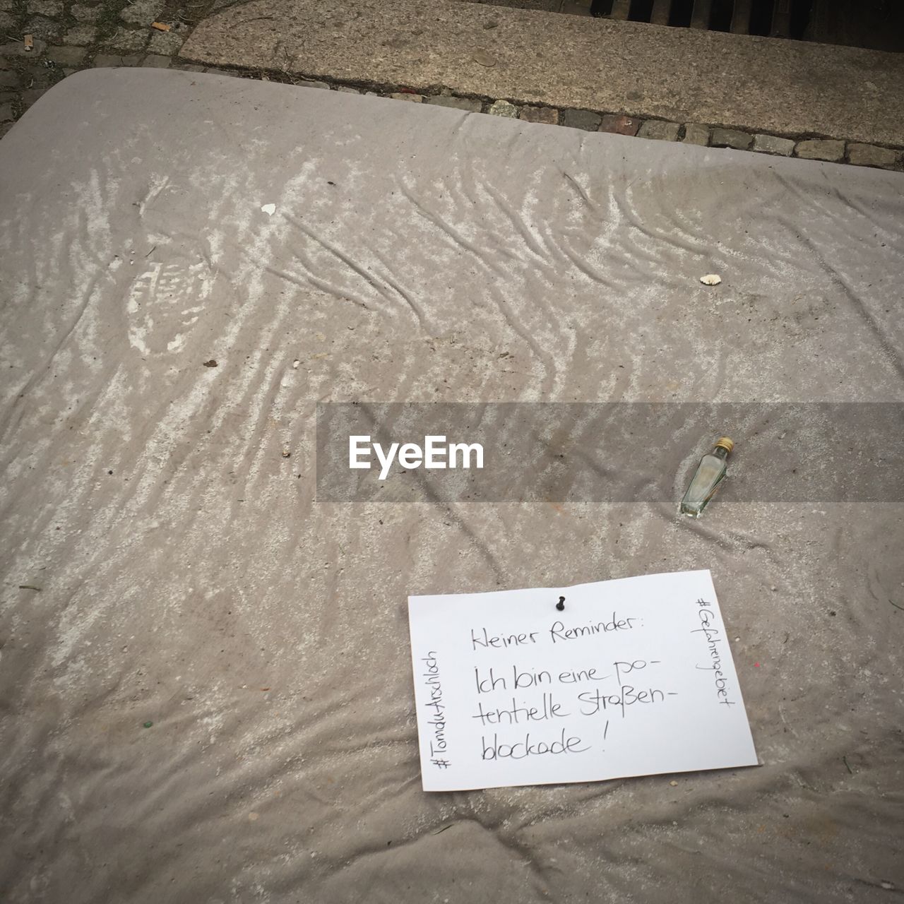 High angle view of text on paper at street