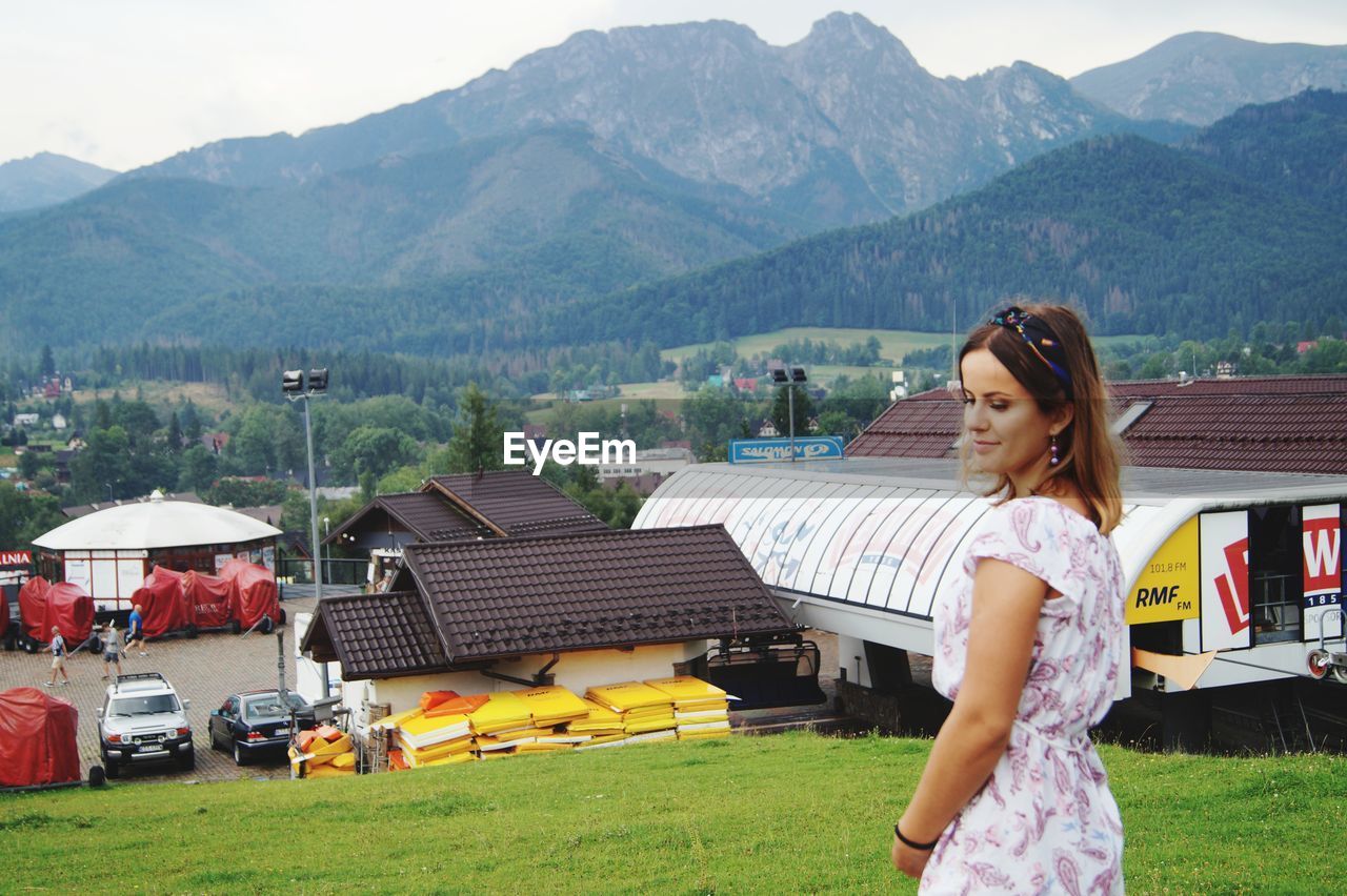 WOMAN STANDING ON A MOUNTAIN