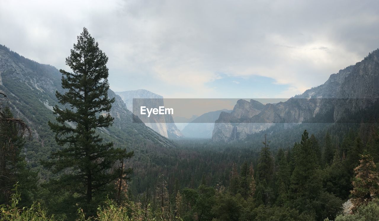 Scenic view of mountains against cloudy sky