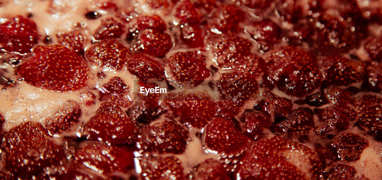 Close-up of strawberry jelly boiling in a saucepan. preparation of strawberry jelly, marmalade