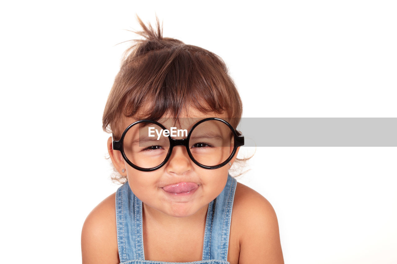 Portrait of little girl against white background