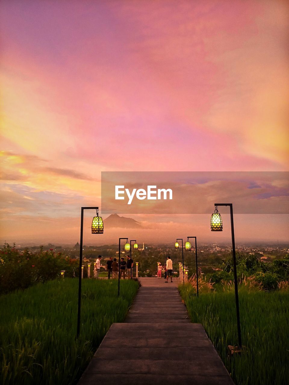 Street lights on footpath at sunset