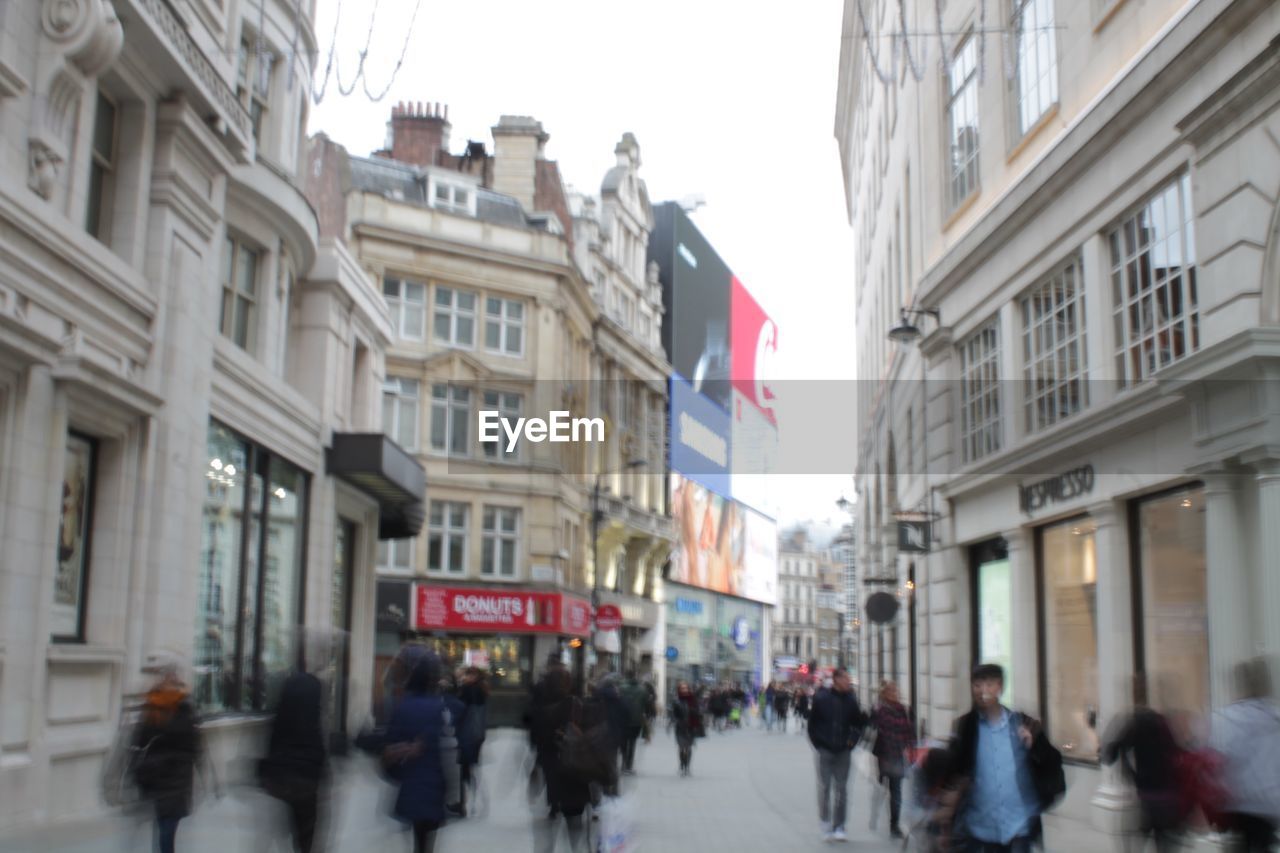 GROUP OF PEOPLE WALKING IN CITY