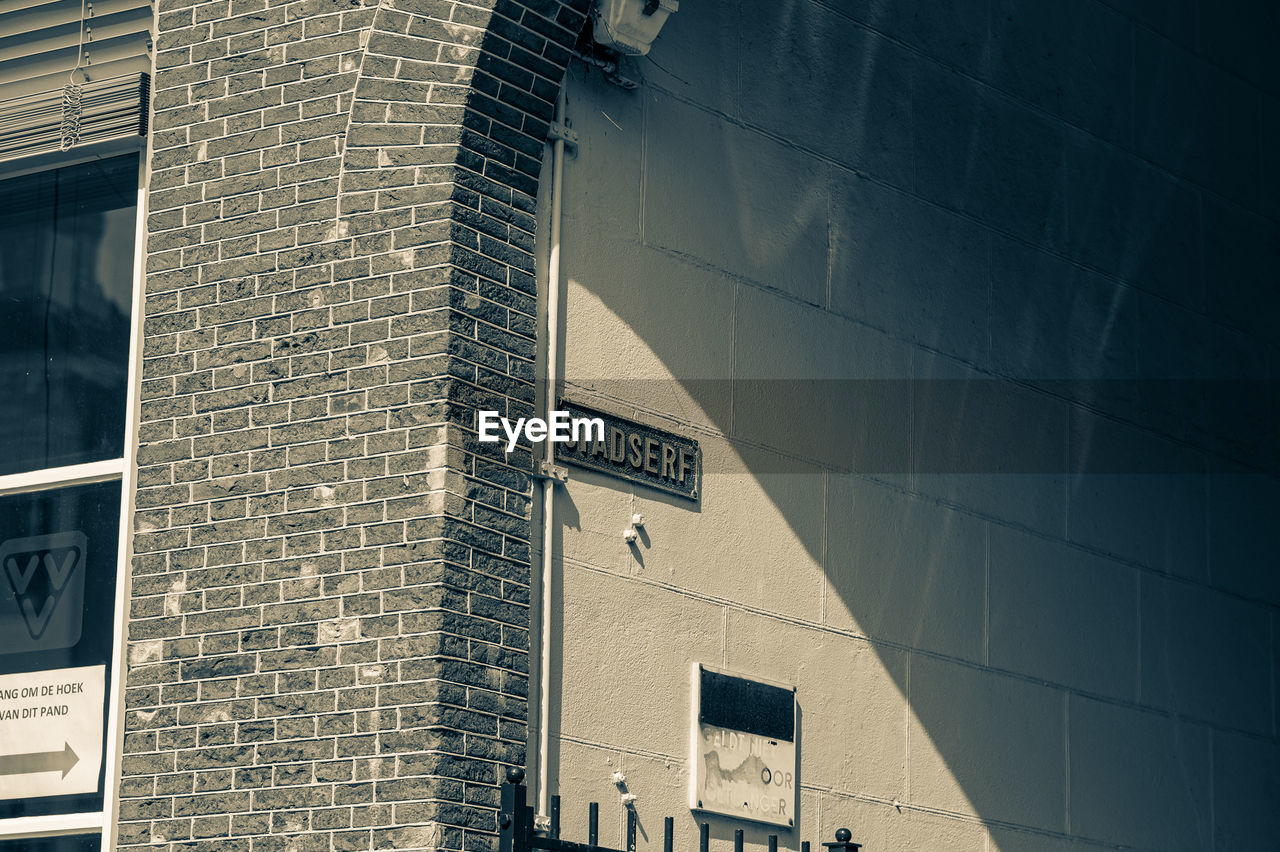 Low angle view of sign on building wall