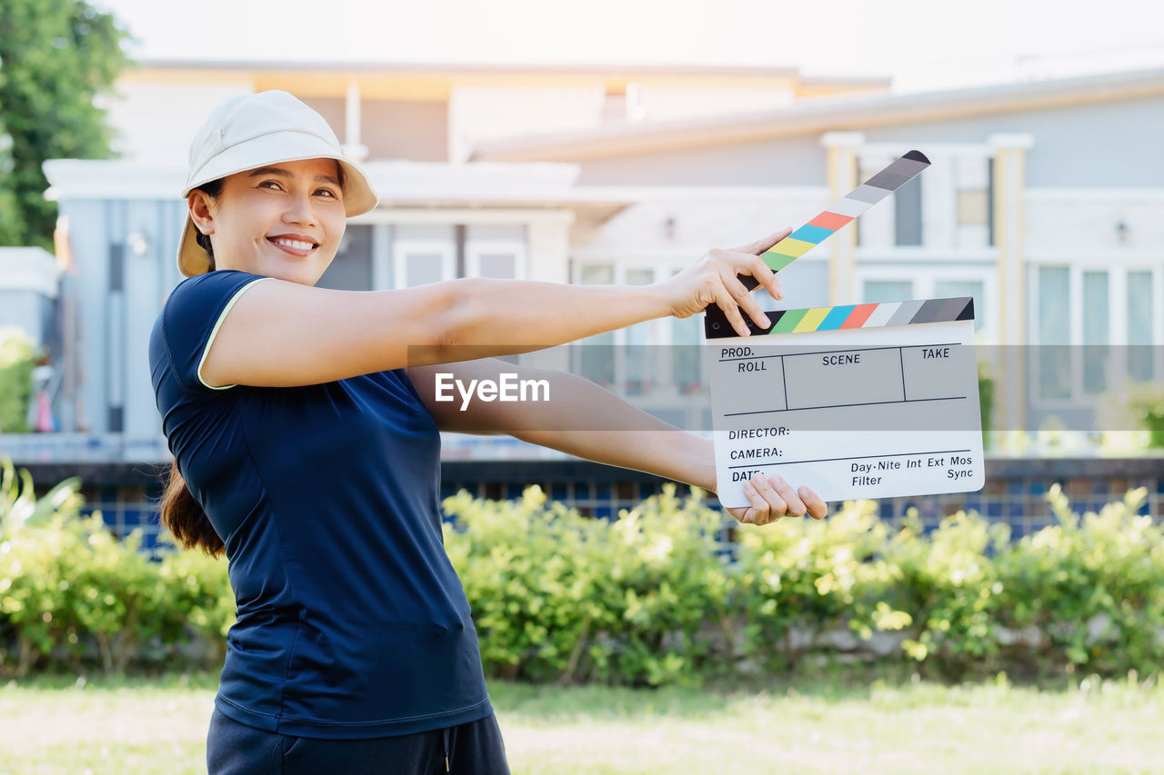 Asian woman holding film slate colors board for movie cinema and television industry