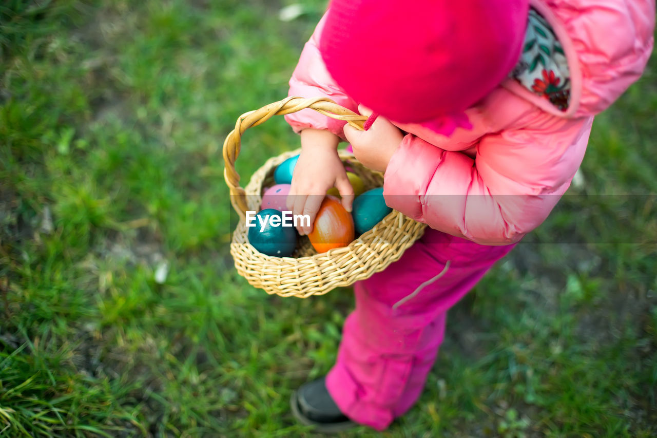 cropped hand of woman holding balloon on field