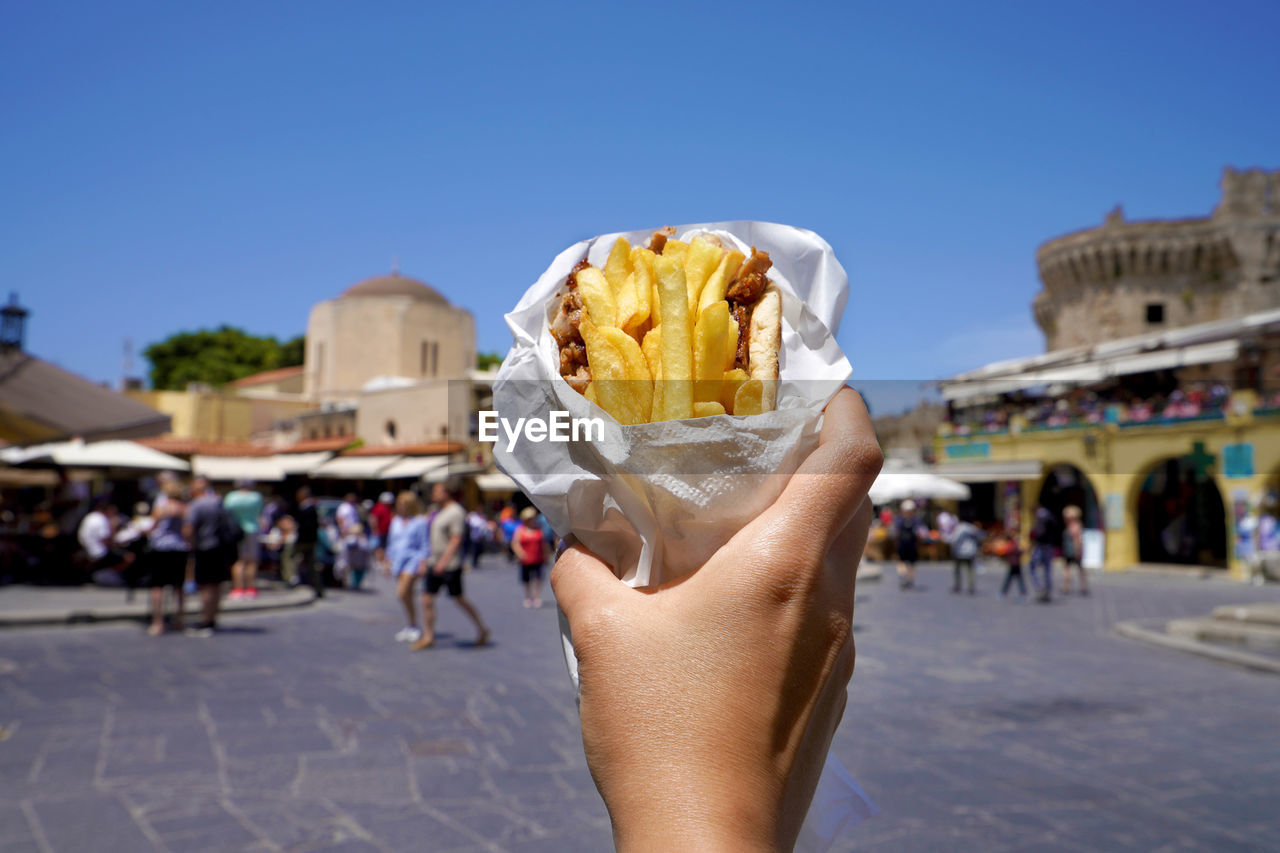 Pita gyros. greek gyros wrapped in pita breads against greek old city square.