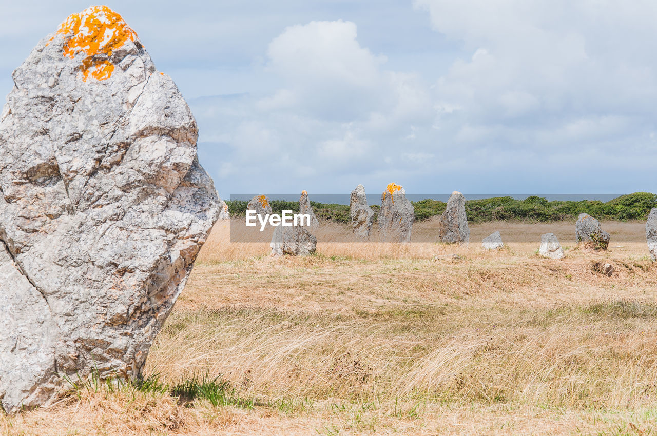 VIEW OF ROCKS ON FIELD AGAINST SKY