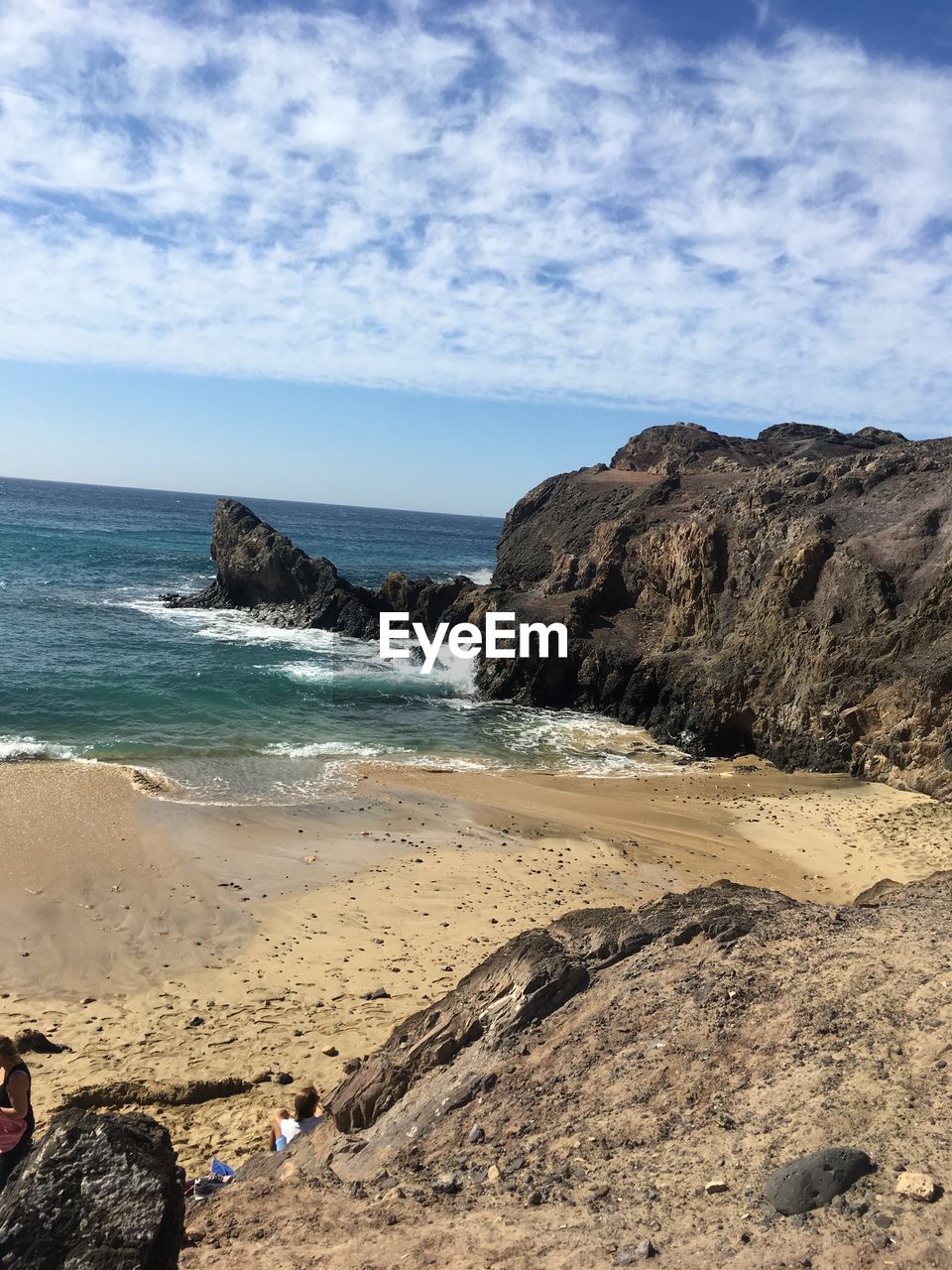 Scenic view of rocks on beach against sky