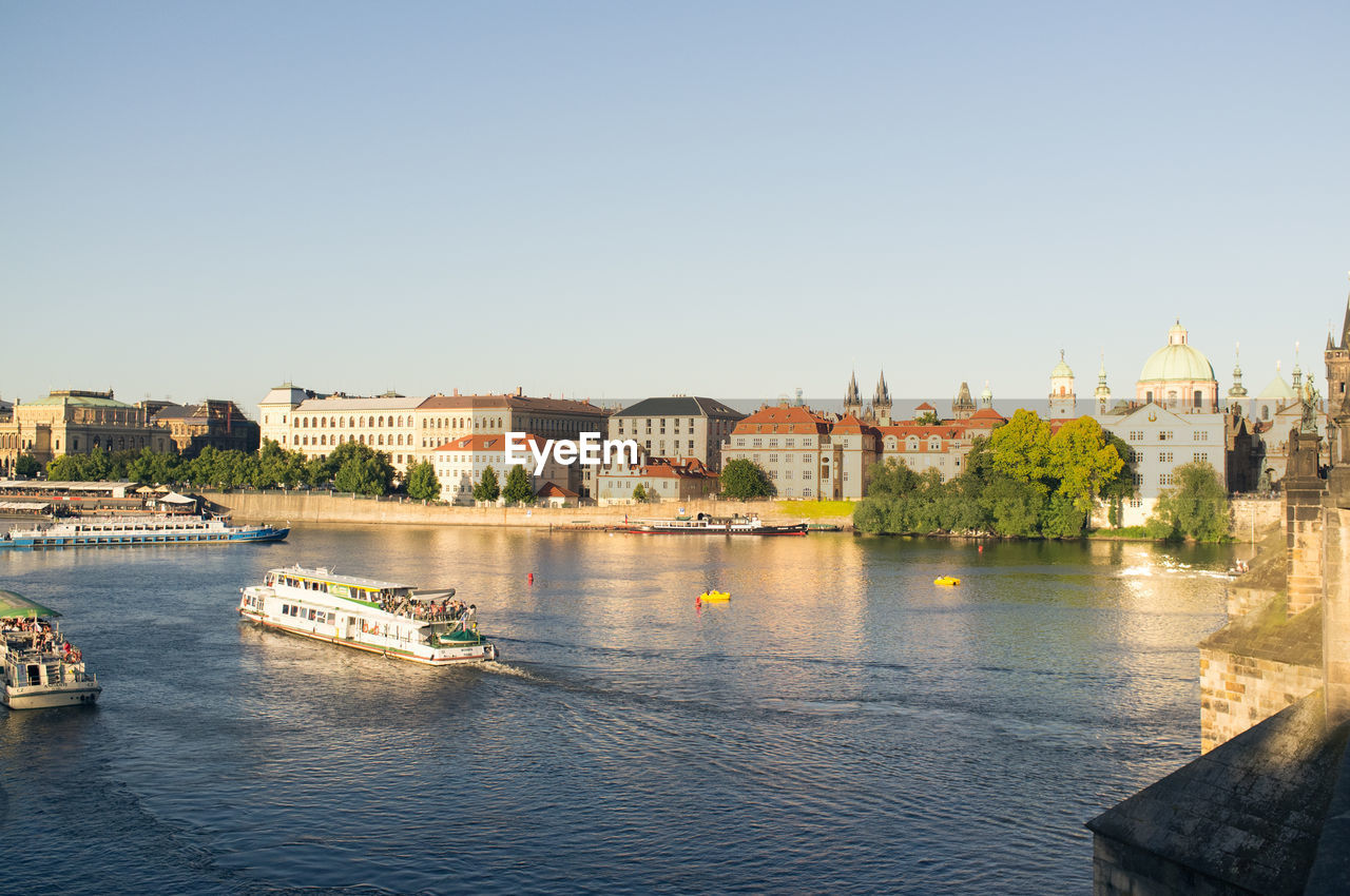 High angle view of ship in river against buildings and clear sky in city