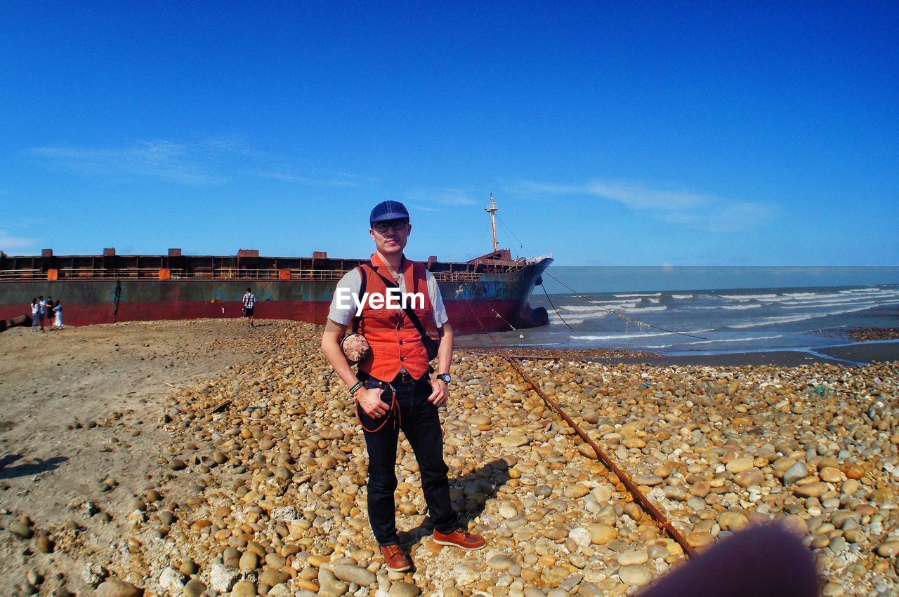 Full length of man standing on beach