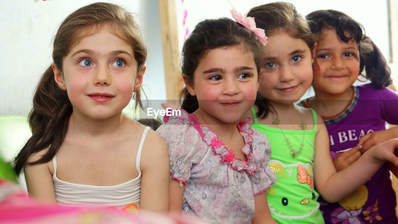 Portrait of cute smiling girls at home