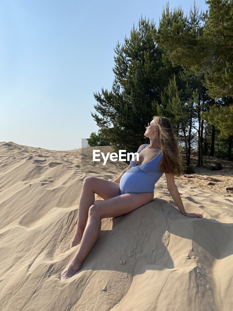 low angle view of young woman standing on rock