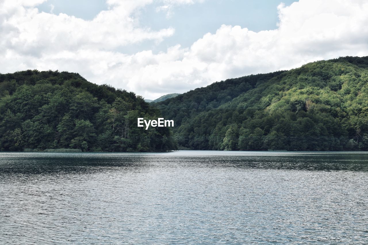 Scenic view of lake and mountains against sky