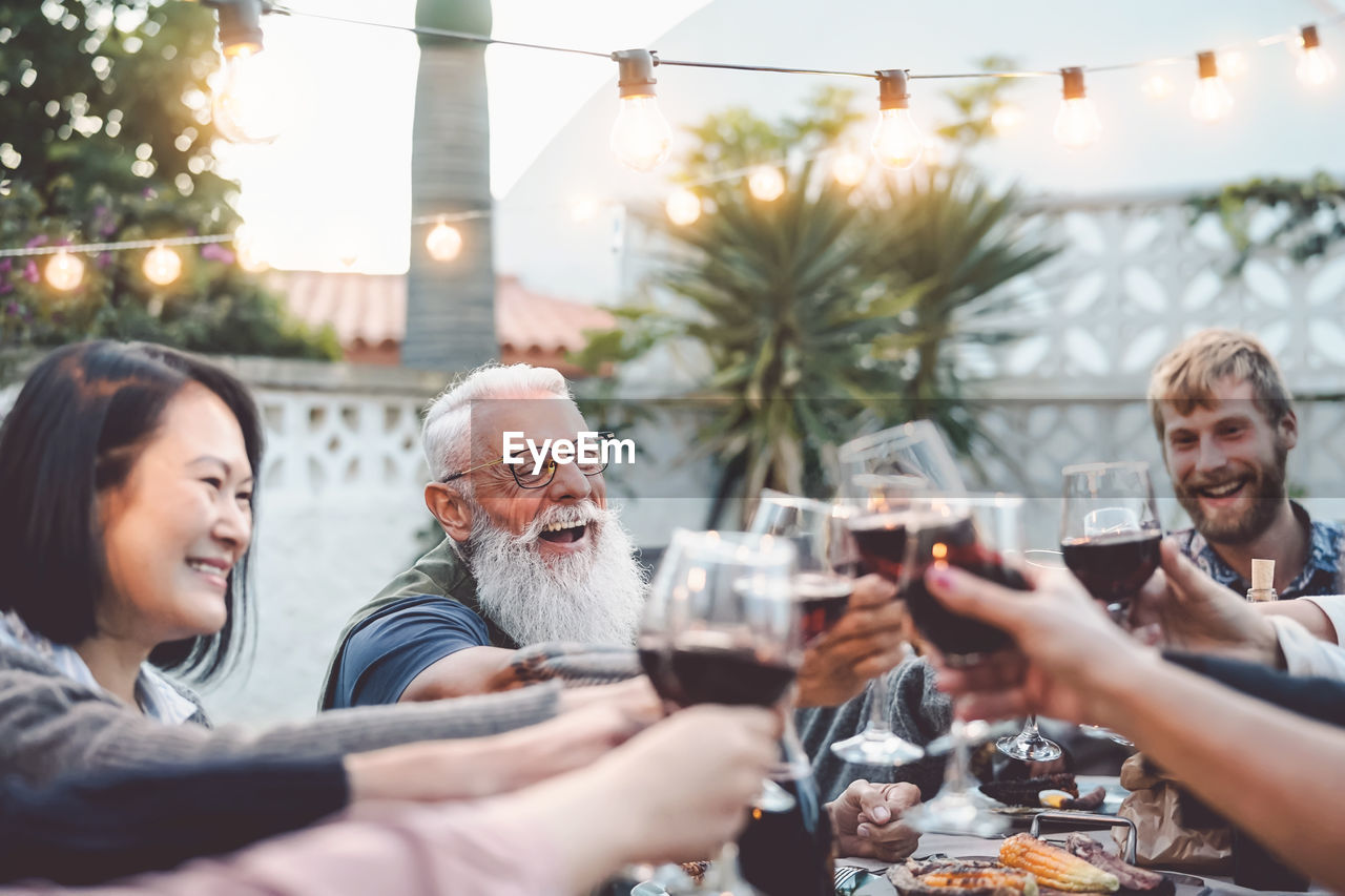 People toasting glasses on table