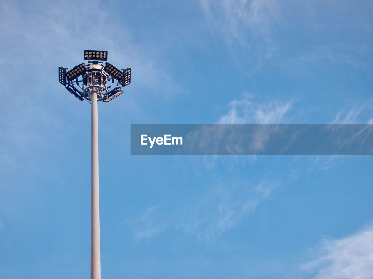 Low angle view of street light against blue sky