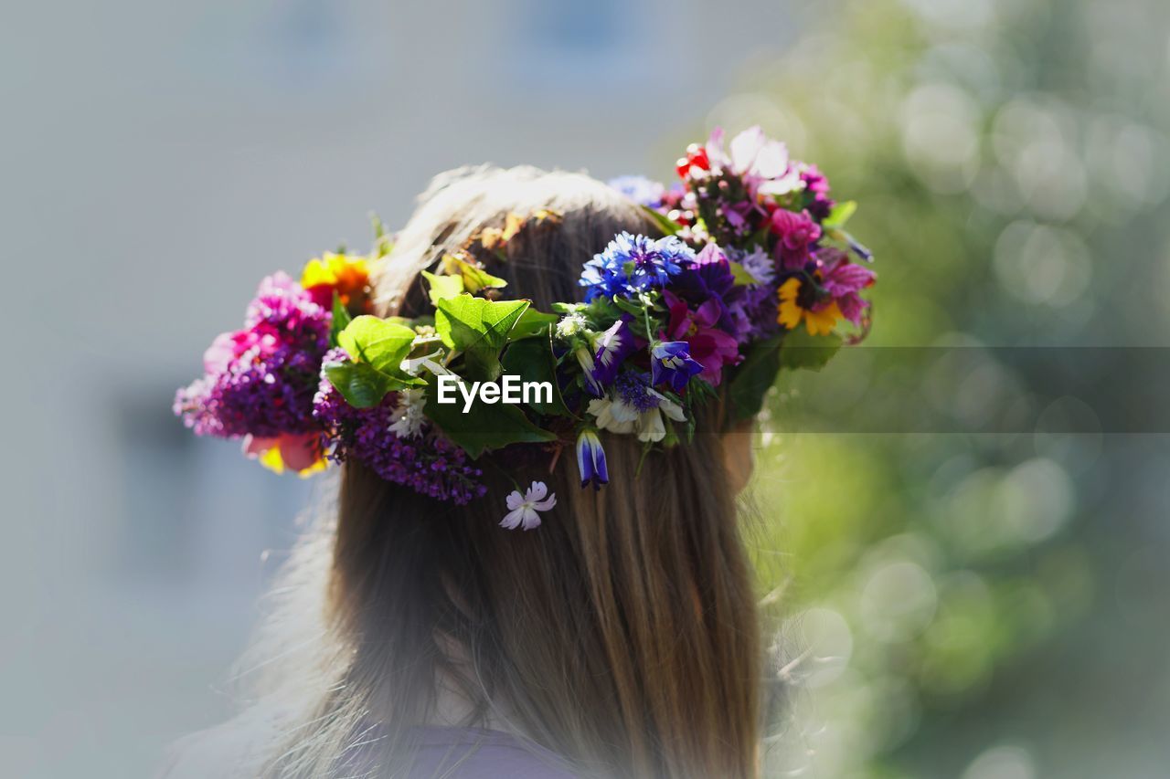 Close-up of girl wearing flowers