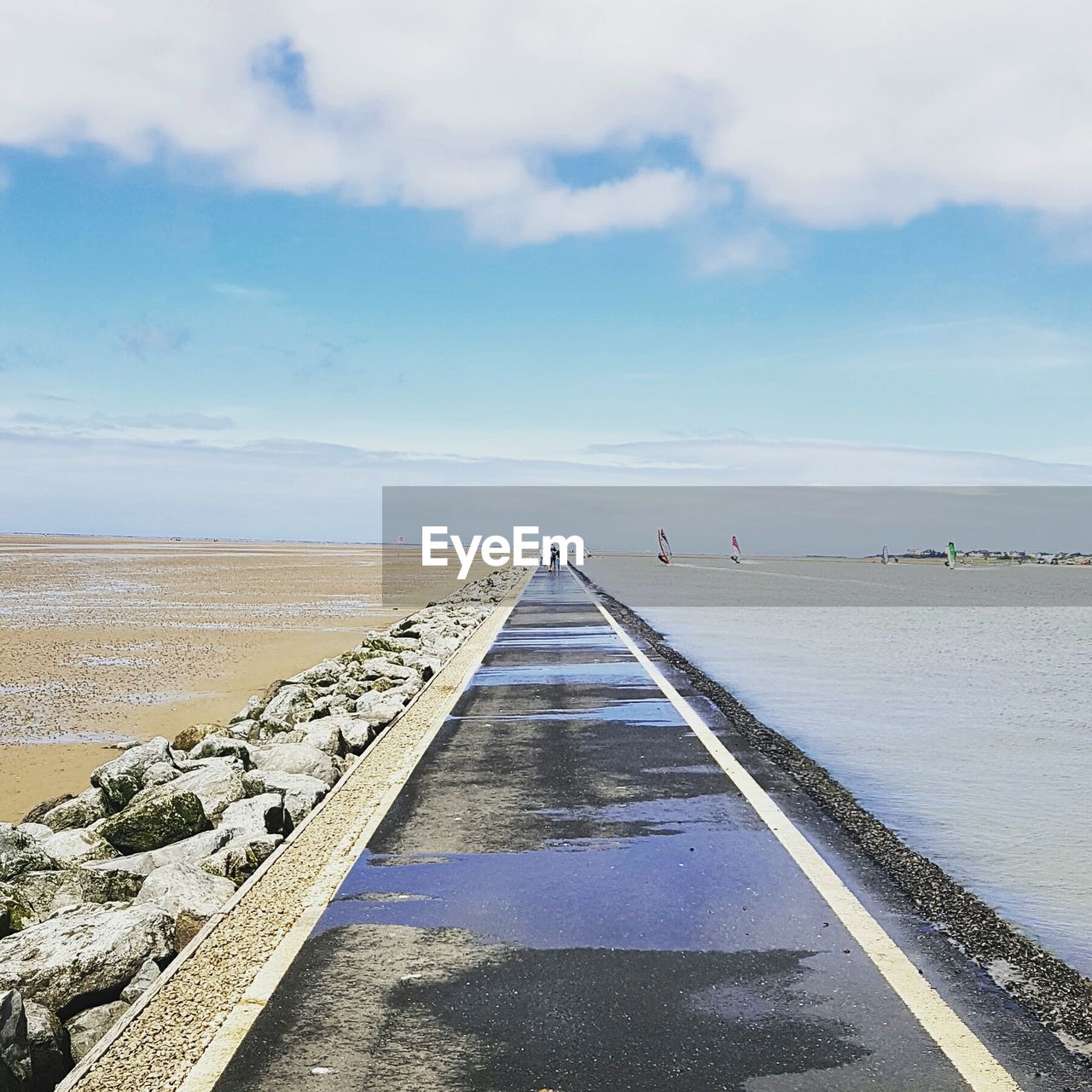 Empty jetty leading to calm sea