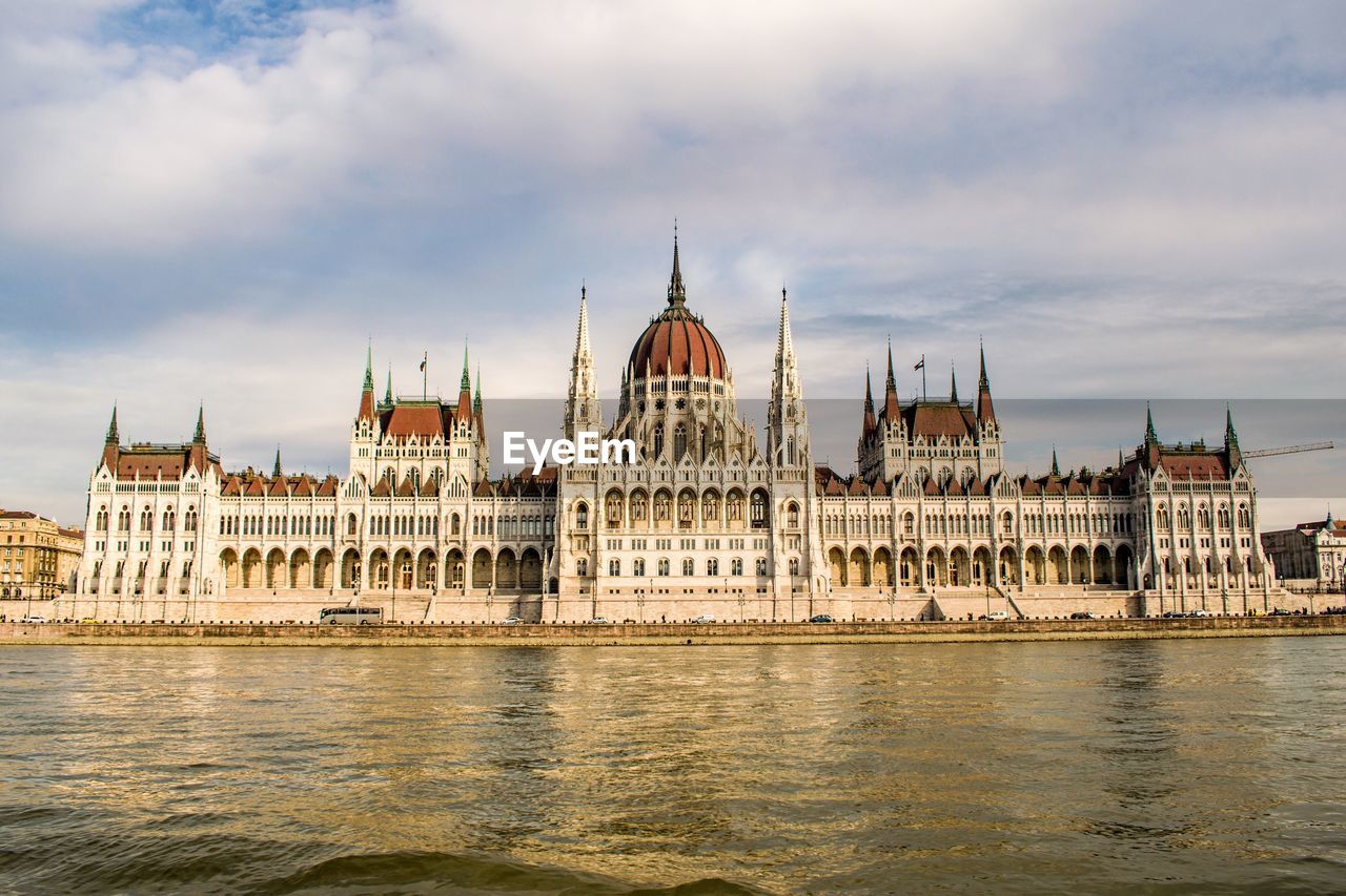 View of hungarian parliament building against cloudy sky