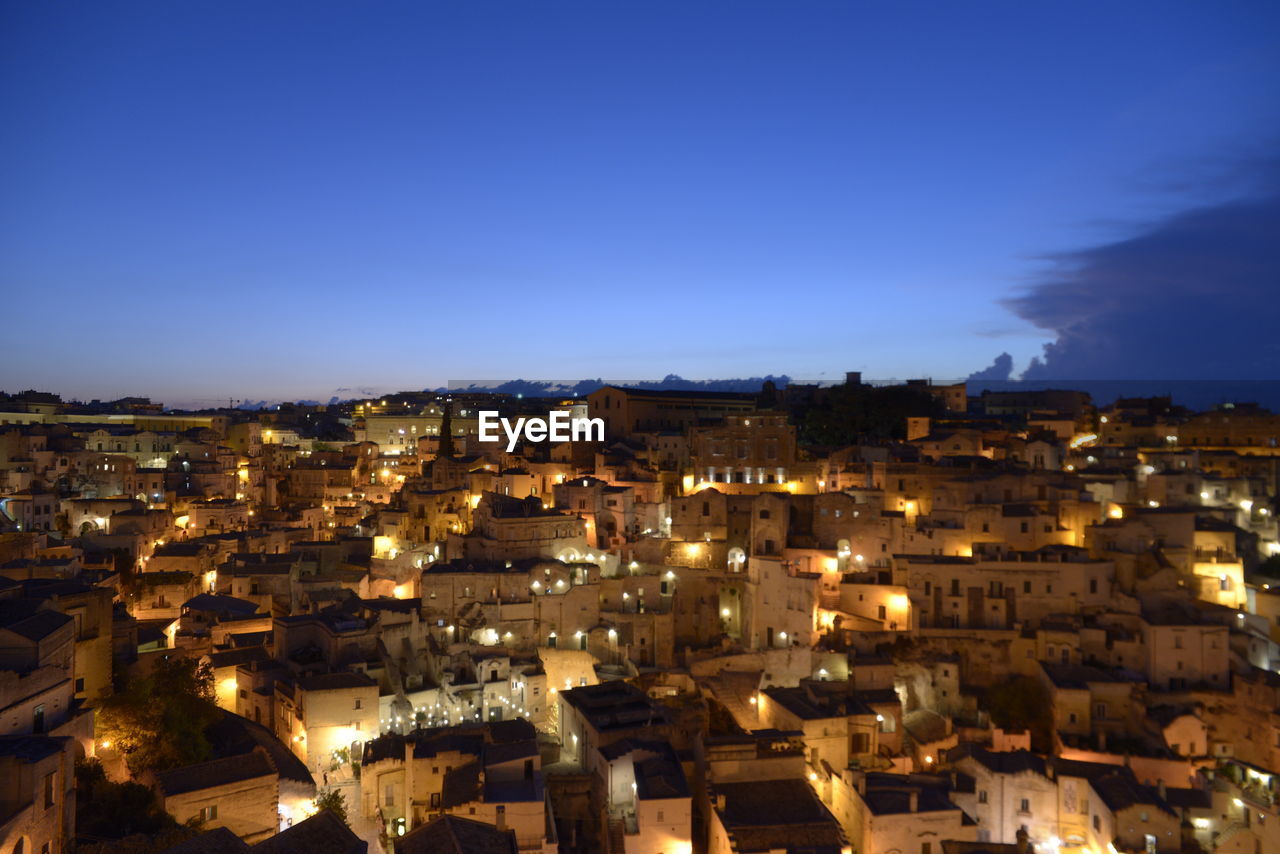 High angle view of illuminated townscape against sky at night