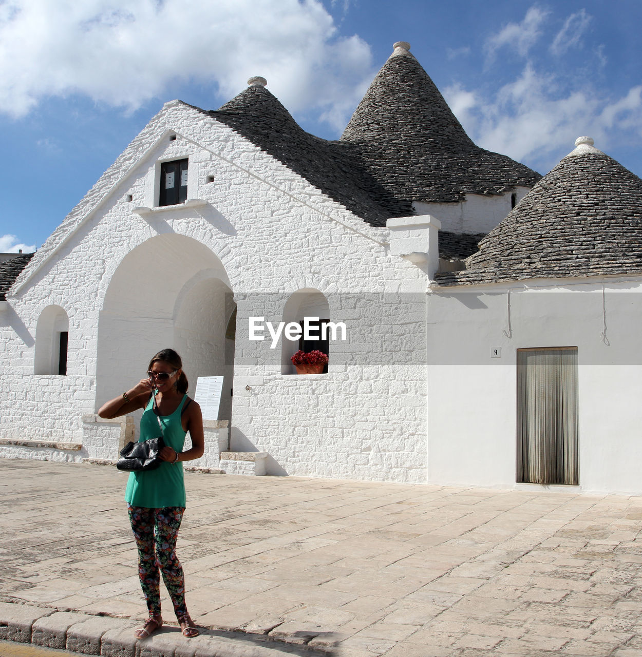 Full length of woman standing against building