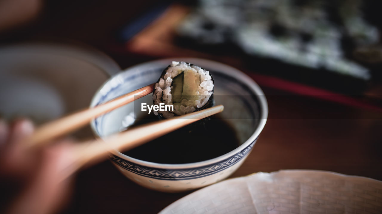 Close-up of sushi on chopsticks