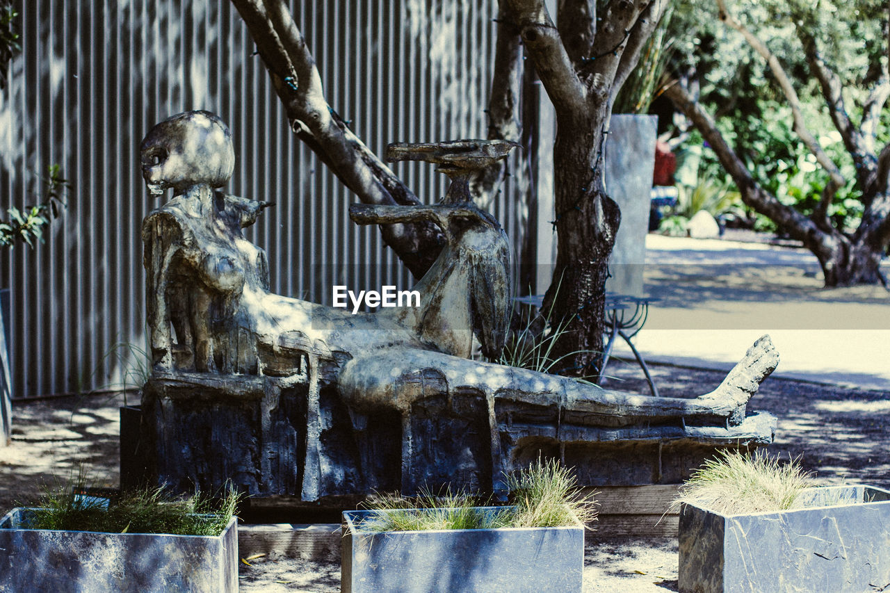 Close-up of sculpture by wall on sunny day