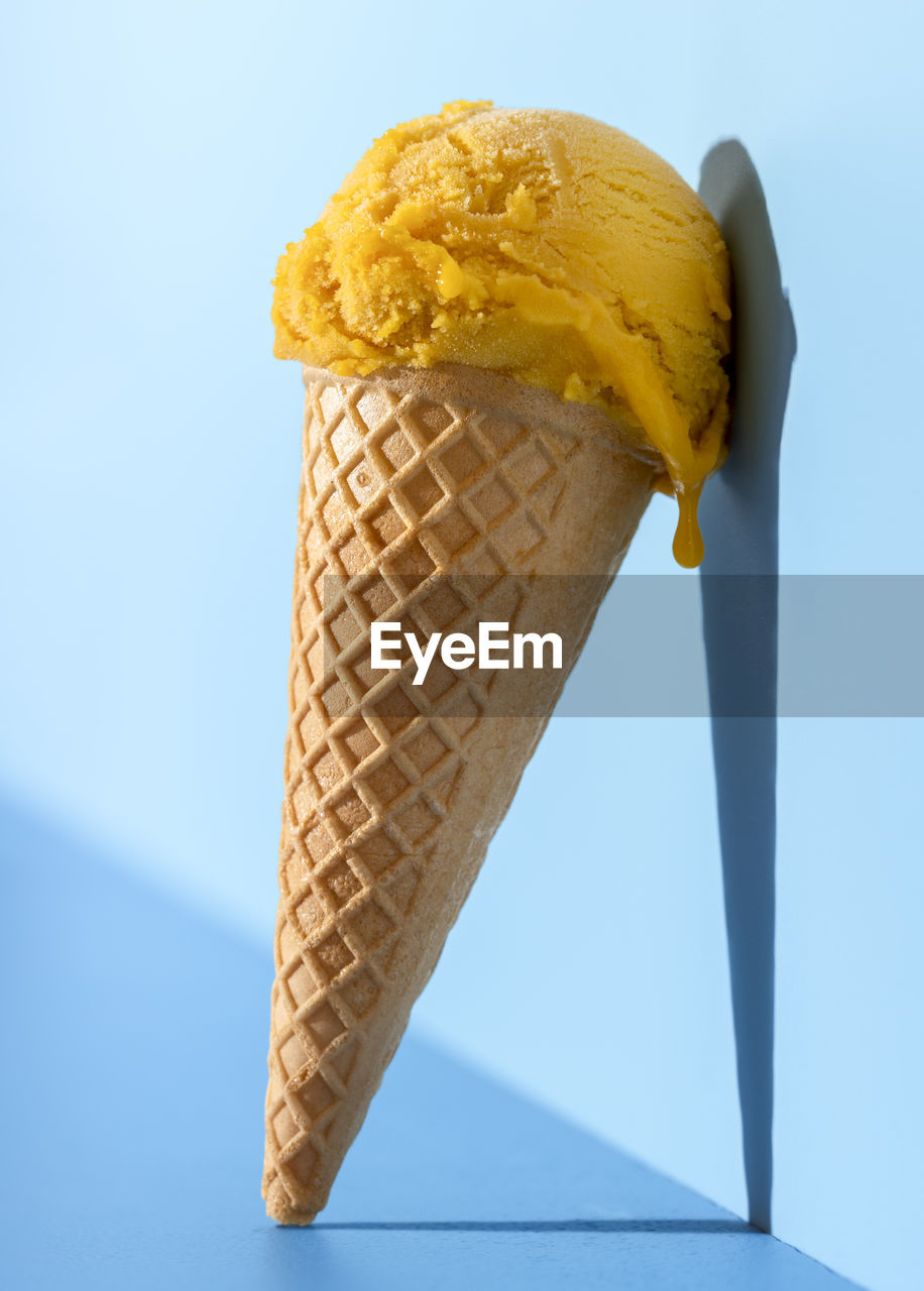 Close-up of ice cream against blue sky
