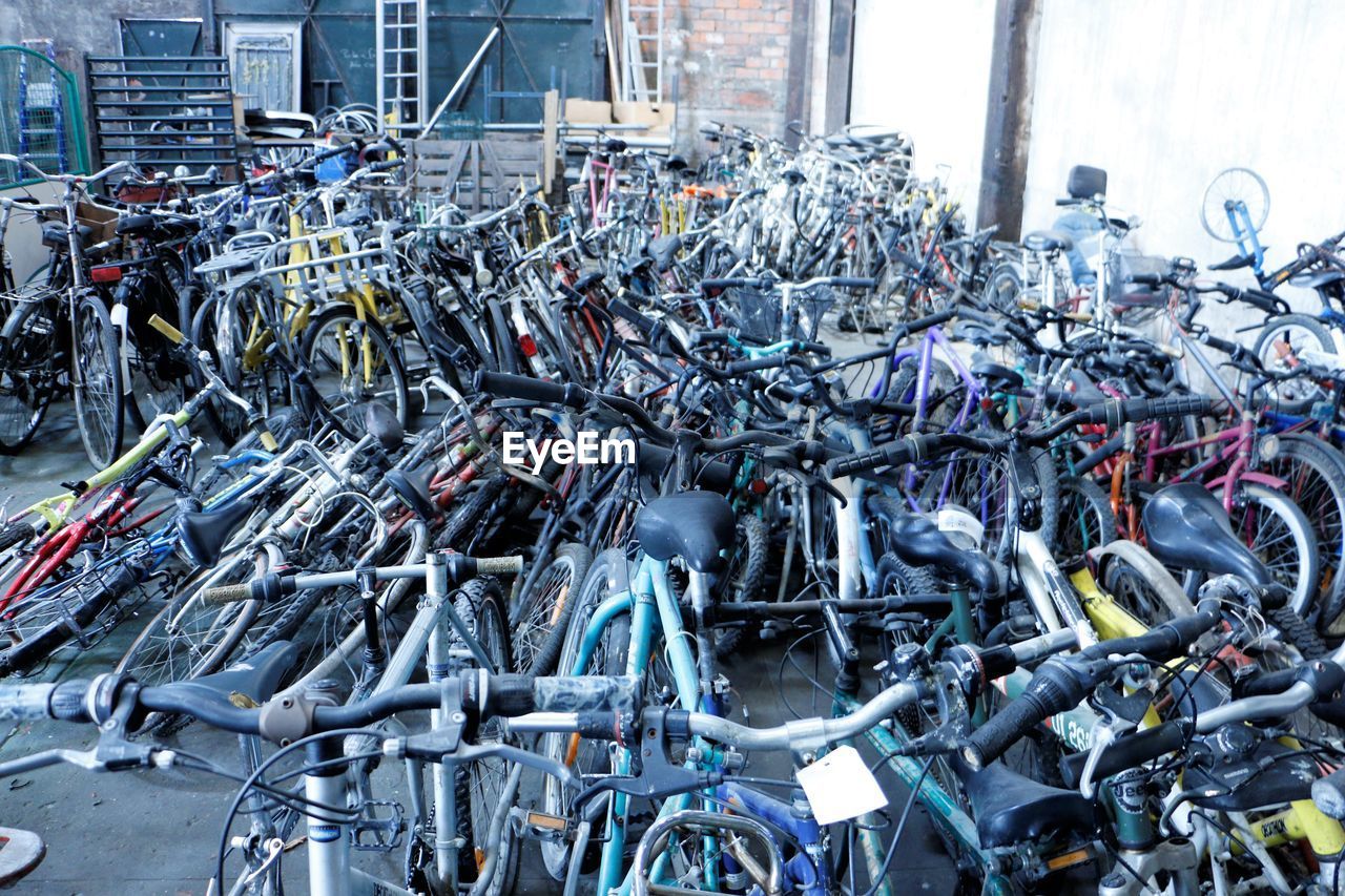 VIEW OF BICYCLES IN ROW OF METAL BRIDGE