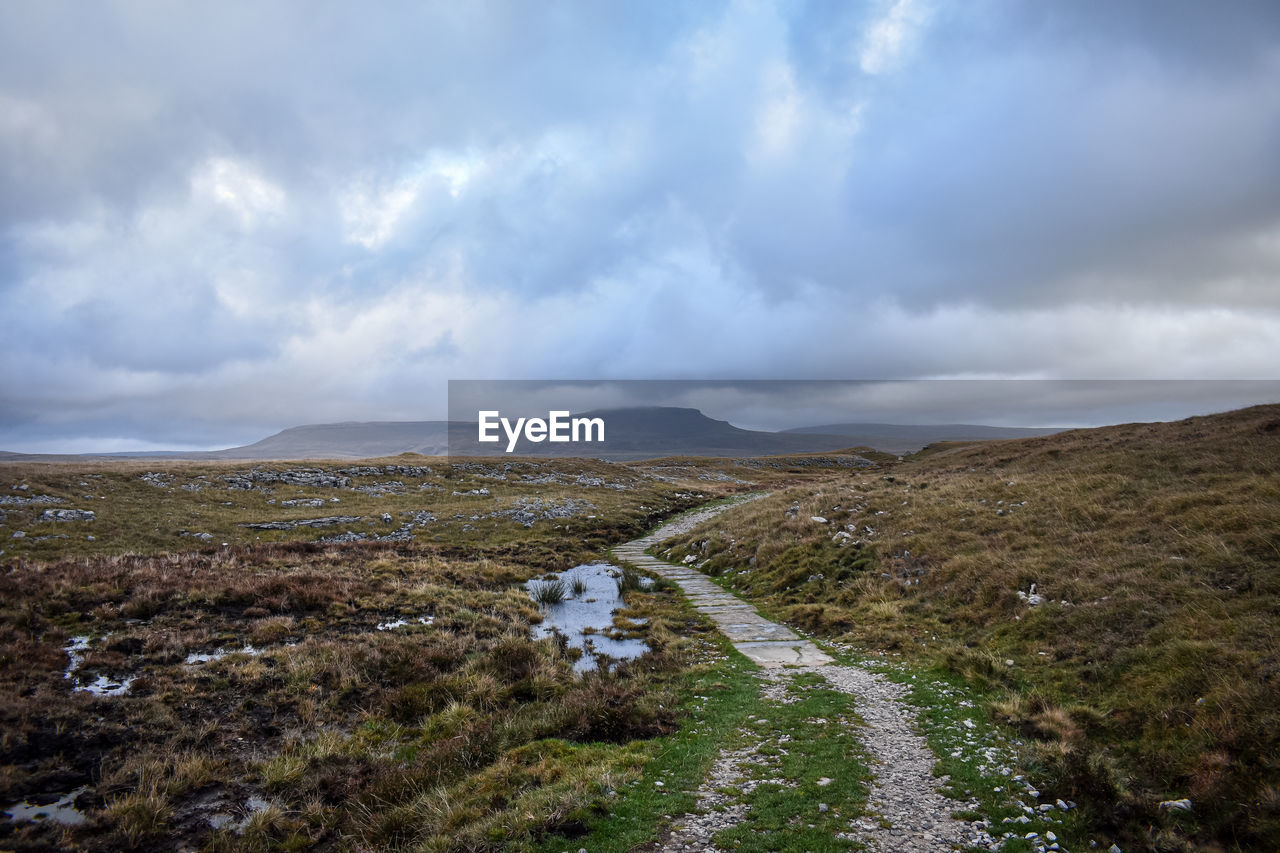 cloud, environment, sky, landscape, mountain, nature, scenics - nature, sea, wilderness, coast, land, beauty in nature, highland, no people, horizon, travel, water, travel destinations, plateau, ridge, non-urban scene, overcast, plant, dramatic sky, outdoors, tourism, grass, tranquility, day, rock, rural area, mountain range, road, storm, cloudscape, tundra, tranquil scene, remote, storm cloud, transportation