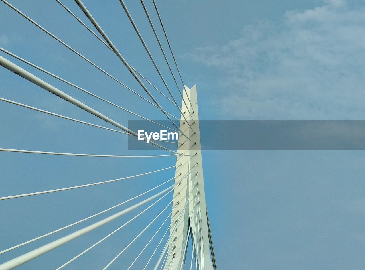 Low angle view of erasmus bridge against sky in rotterdam