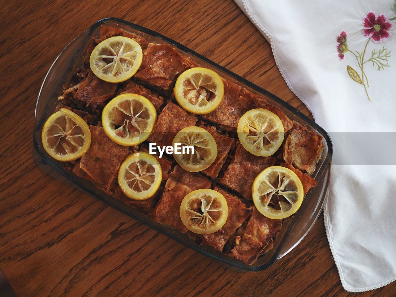 HIGH ANGLE VIEW OF BREAD AND ORANGE ON TABLE