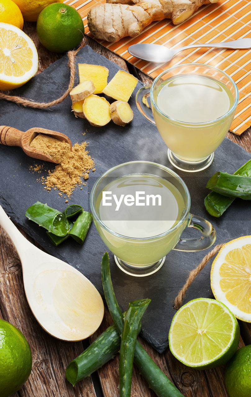 Aloe vera drink with lime and lemon. glass cups on a slate tray.