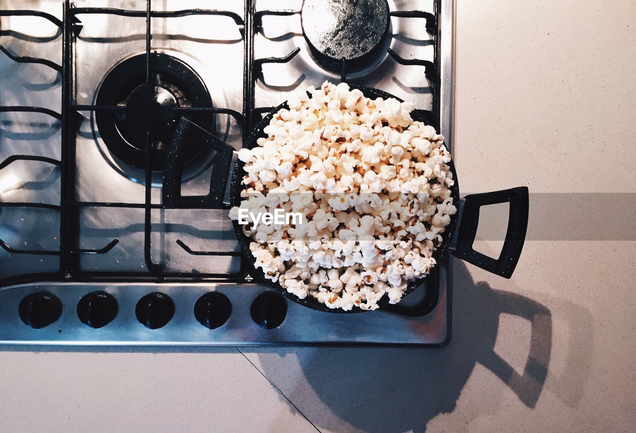 High angle view of popcorns in frying pan on stove at kitchen