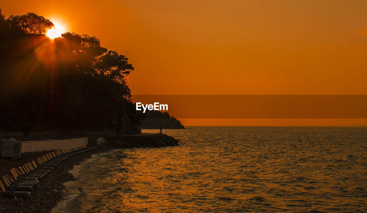 Scenic view of sea against sky at sunset