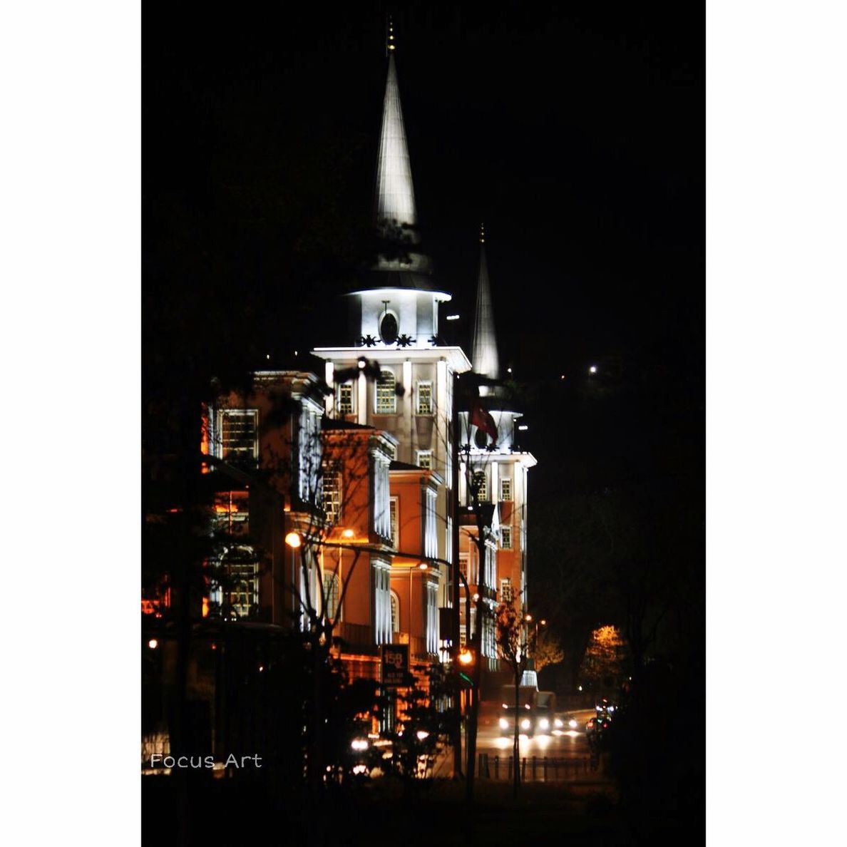 LOW ANGLE VIEW OF ILLUMINATED BUILDINGS AT NIGHT