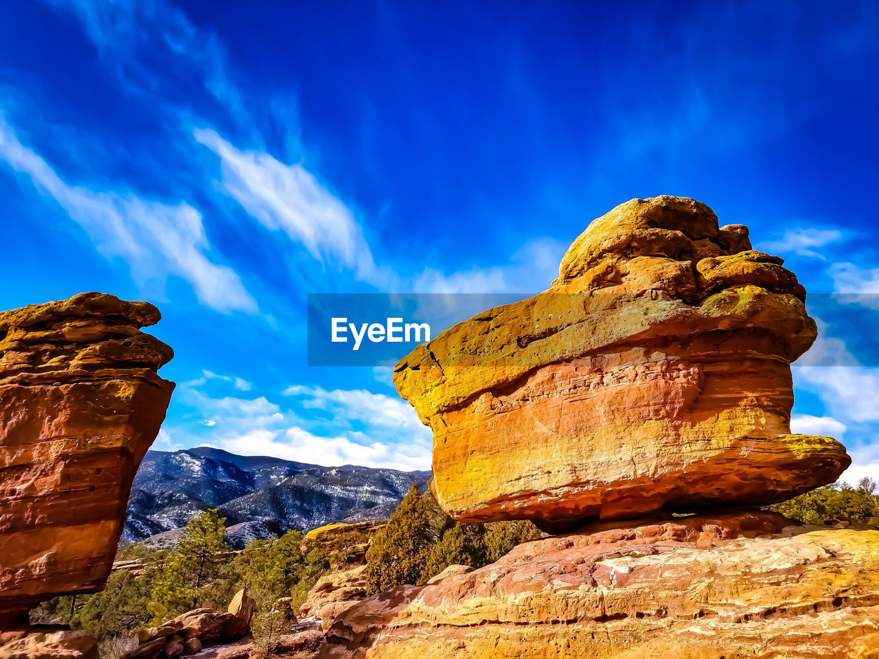 LOW ANGLE VIEW OF ROCK FORMATION BY MOUNTAIN AGAINST SKY
