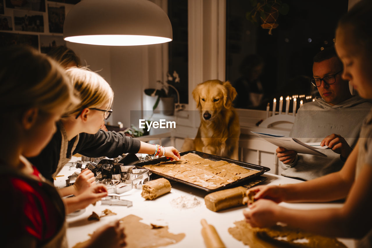 Family at table preparing gingerbread