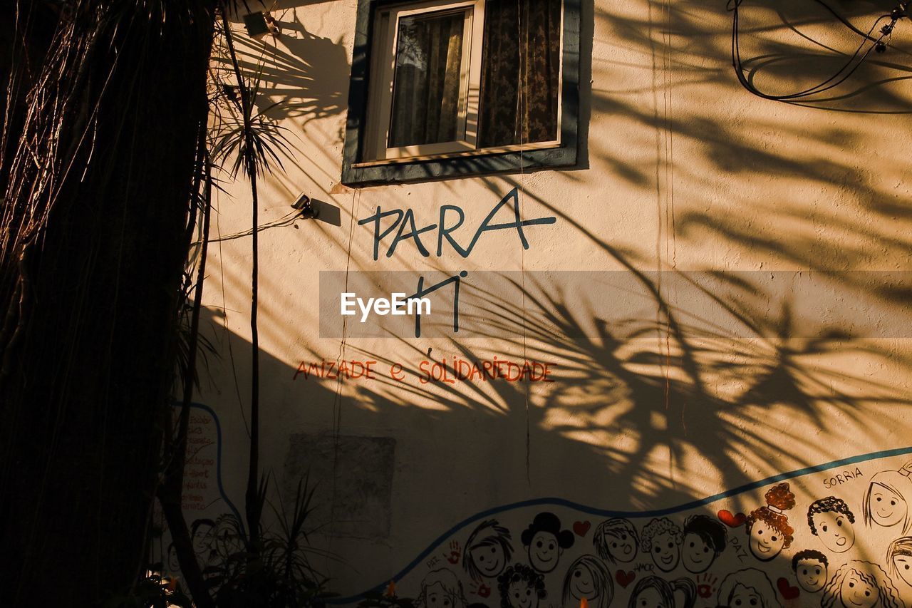 Human mural painting on house wall with shadow