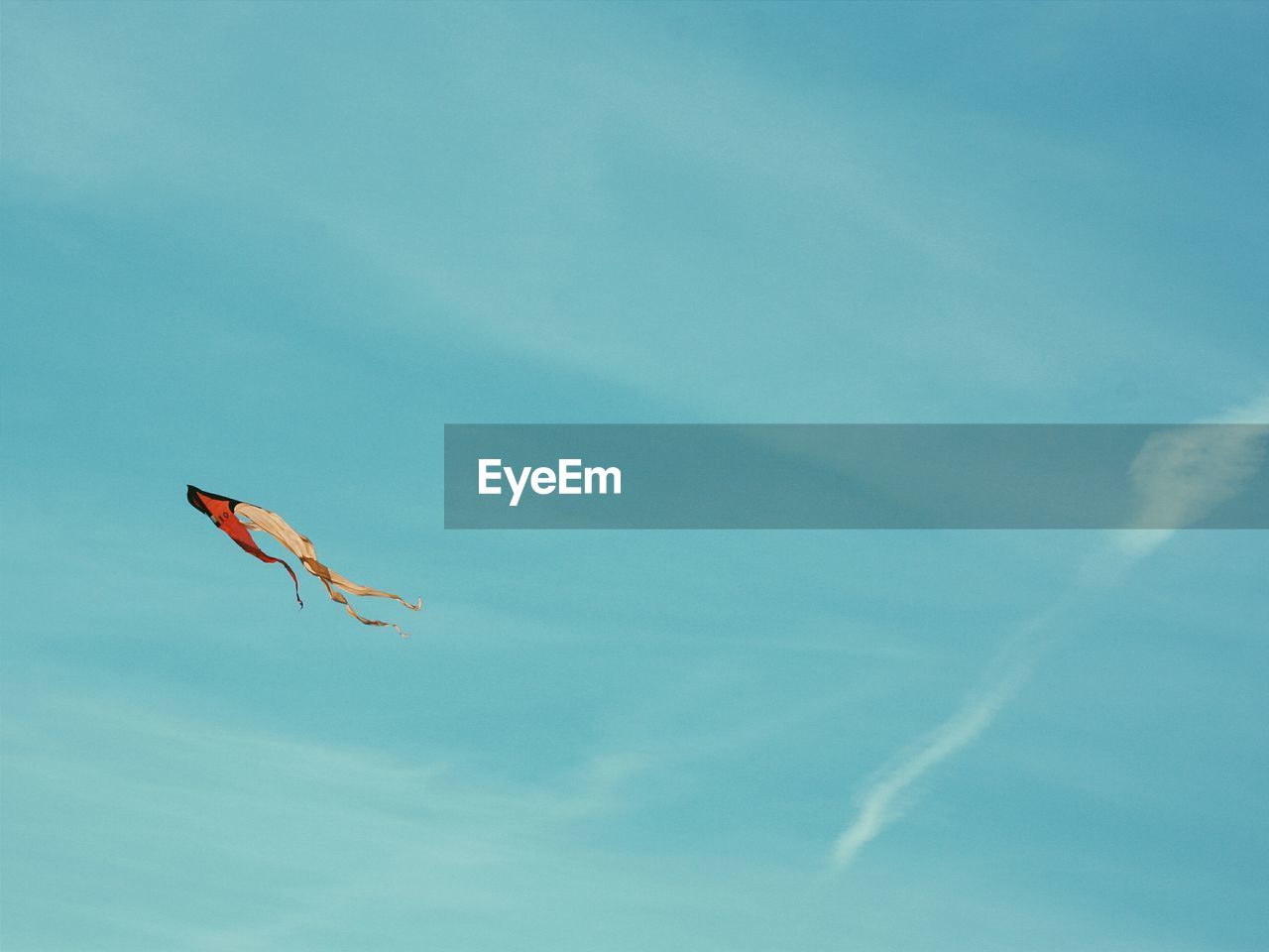 Low angle view of kite flying against blue sky