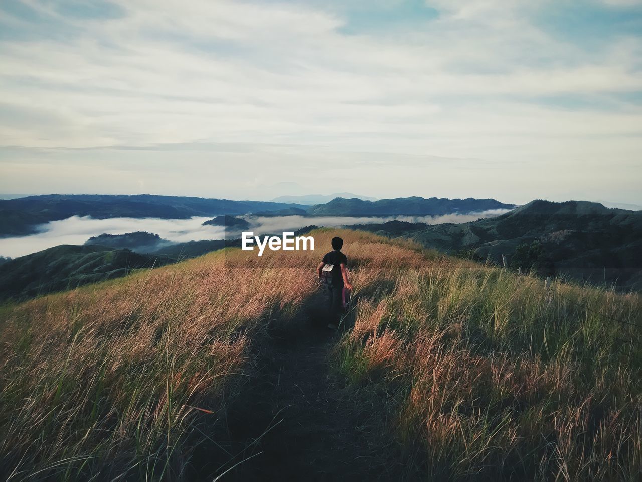 Rear view of person hiking in mountains