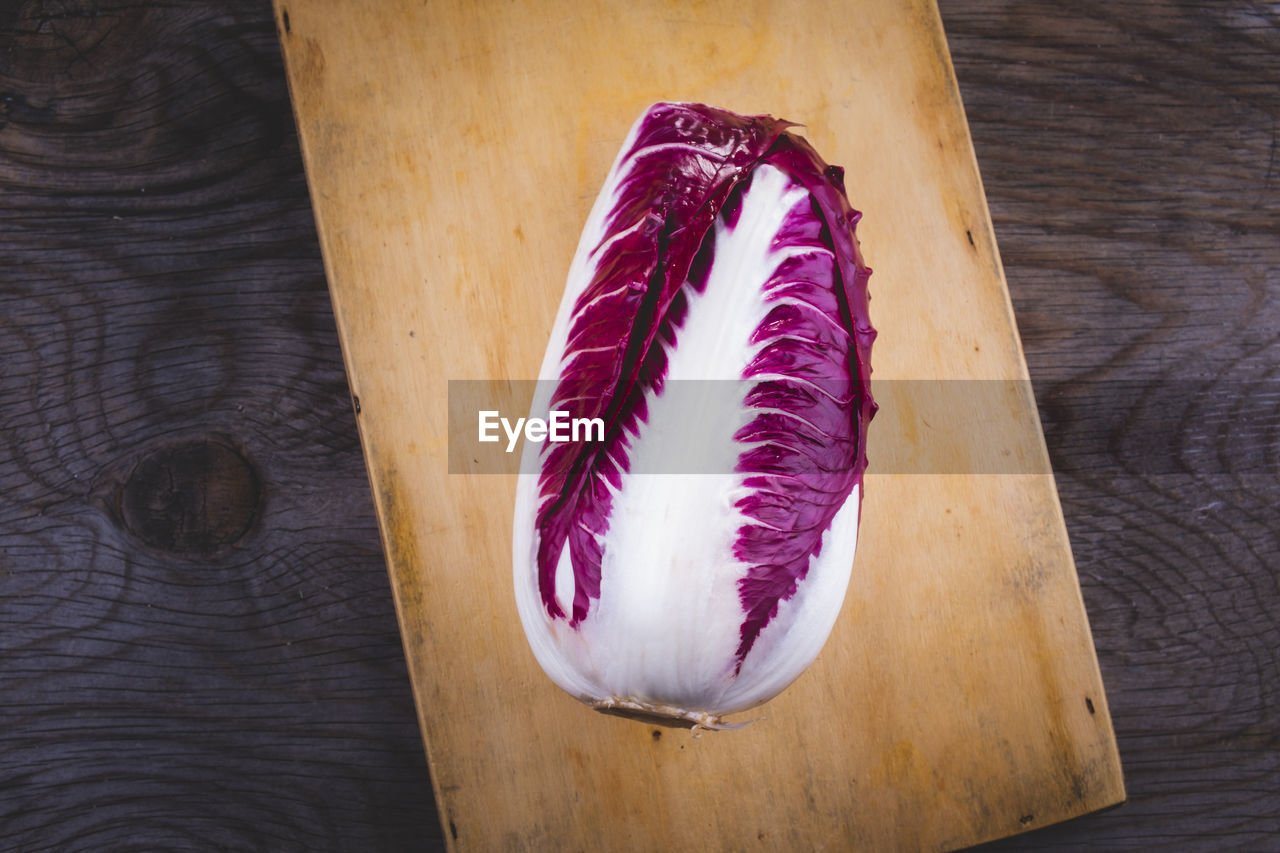 Freshly picked red radicchio arranged on a wooden table