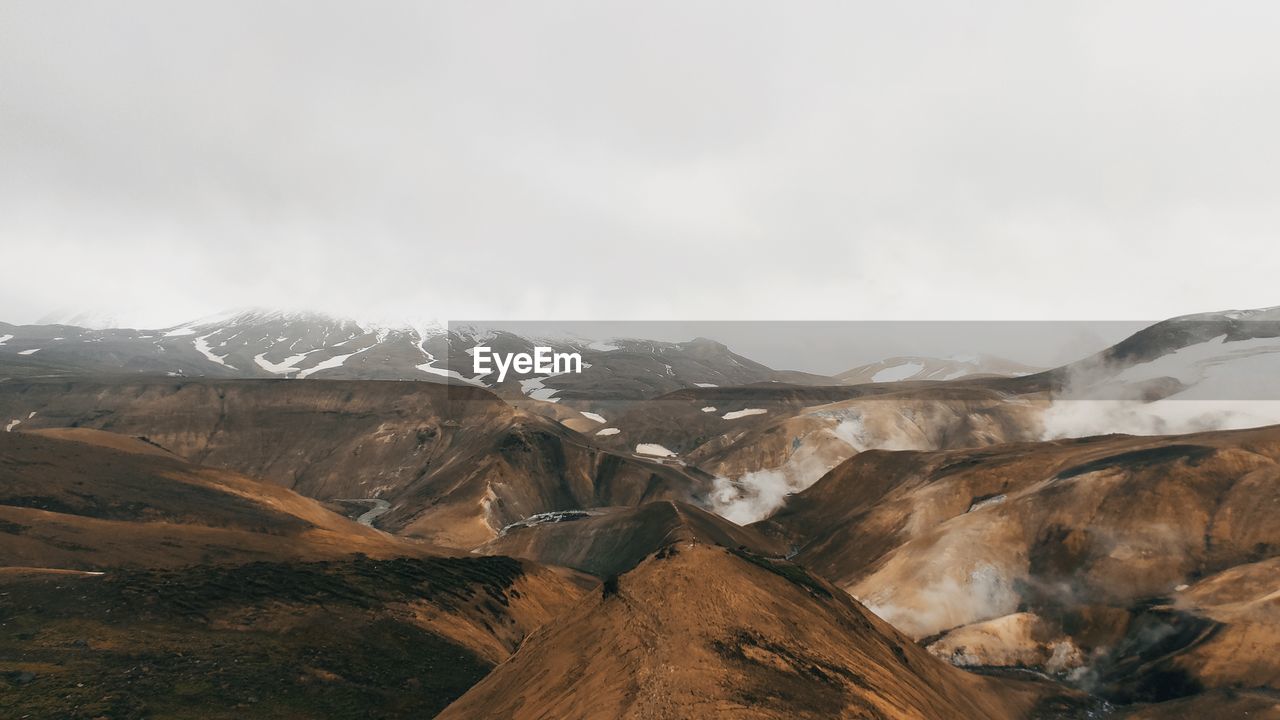 Scenic view of steamy mountain range kerlingafjöll in iceland against sky