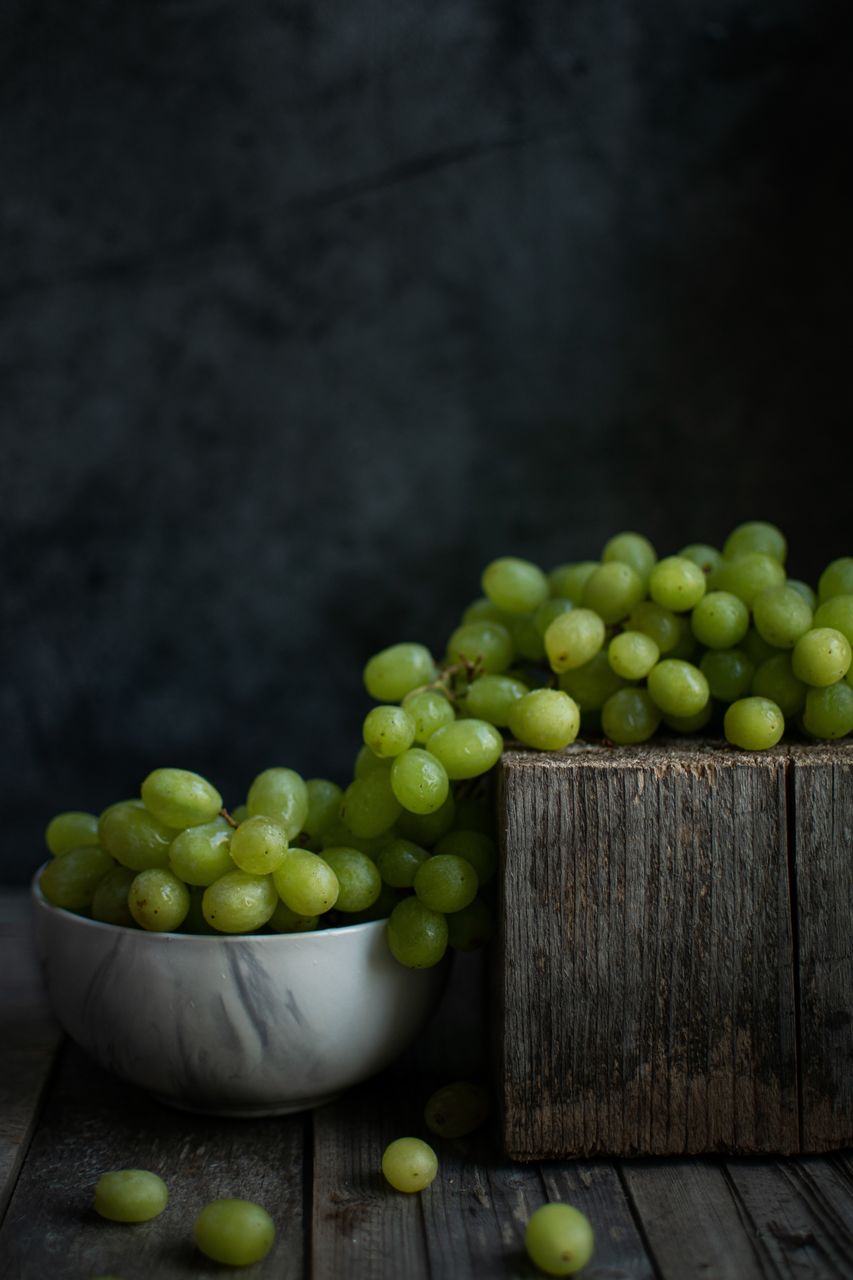 green, food and drink, healthy eating, food, fruit, wellbeing, freshness, wood, produce, plant, studio shot, yellow, no people, grape, green olive, indoors, still life, copy space, leaf, abundance, flower, olive, rustic