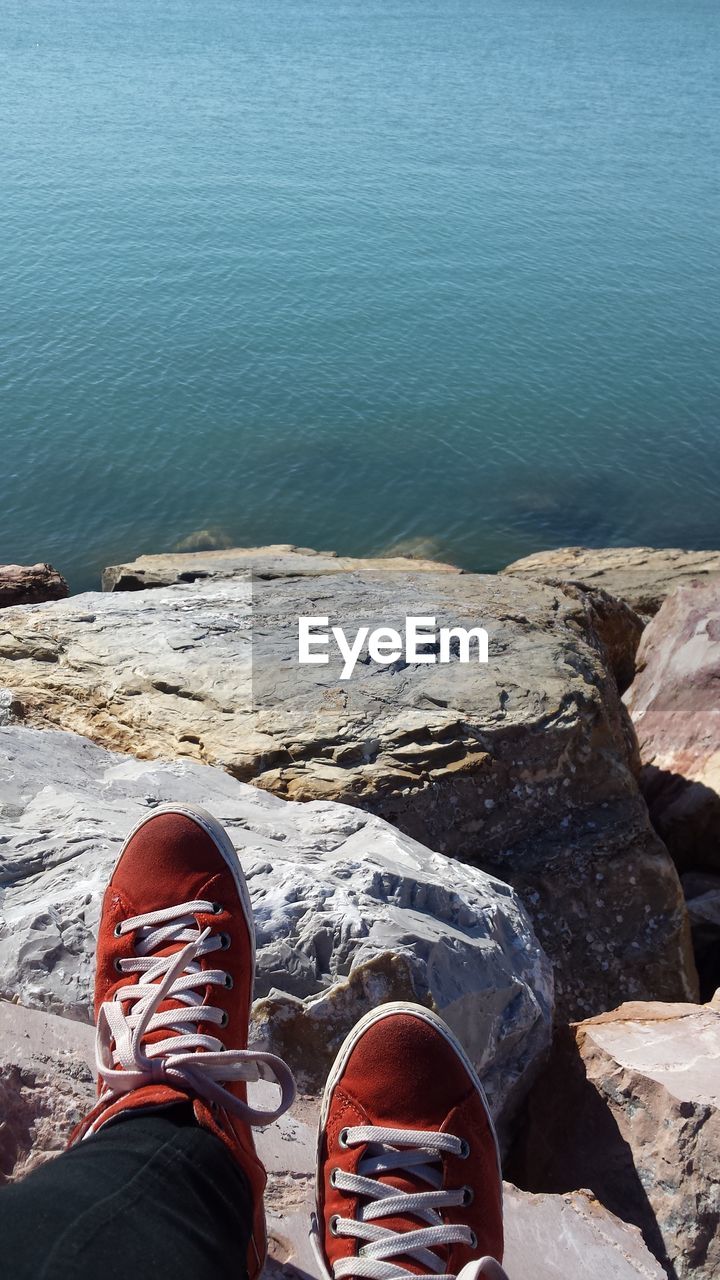 Low section of a man relaxing on shore