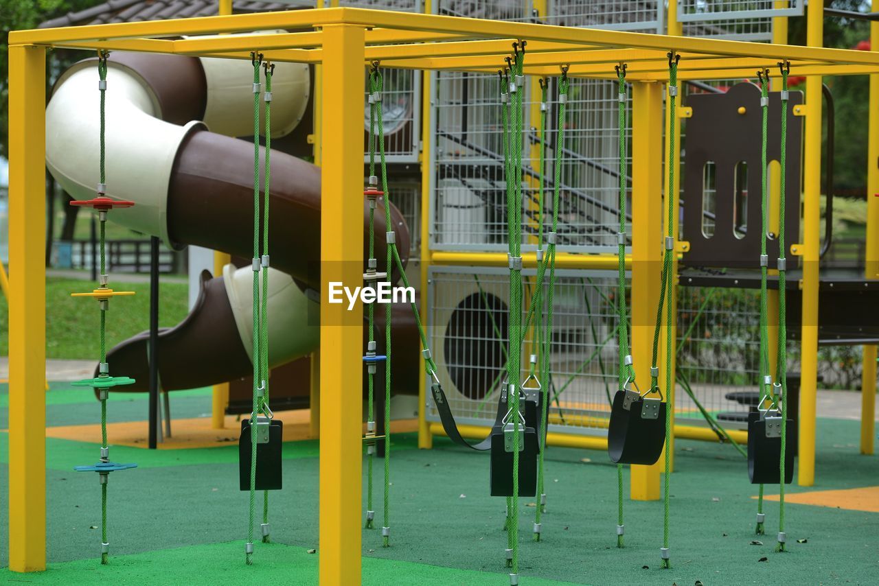 city, playground, outdoor play equipment, public space, sport venue, yellow, recreation, equipment, metal, no people, slide