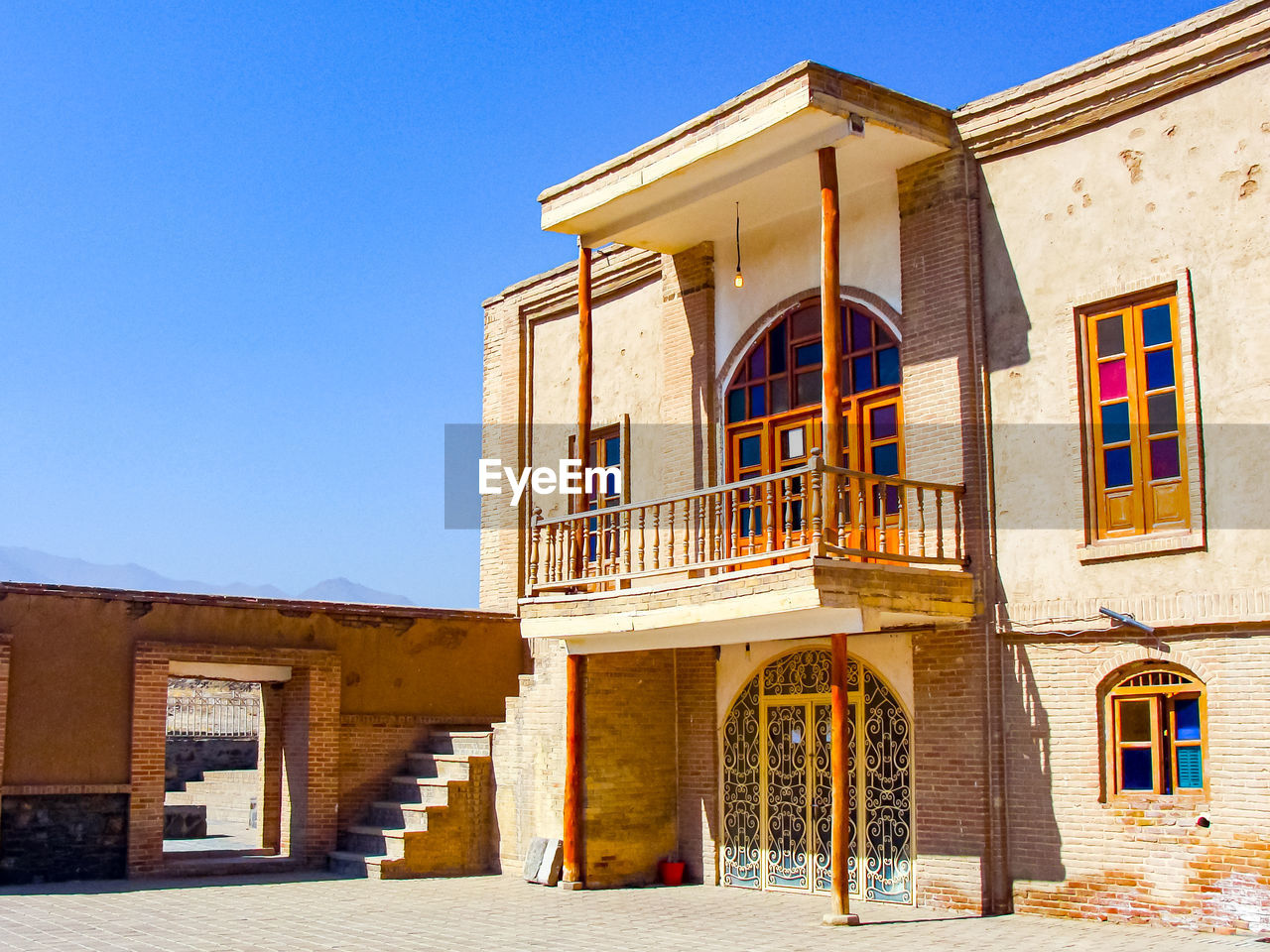 An beautiful old school building with colorful windows with clear sky in hamedan - iran