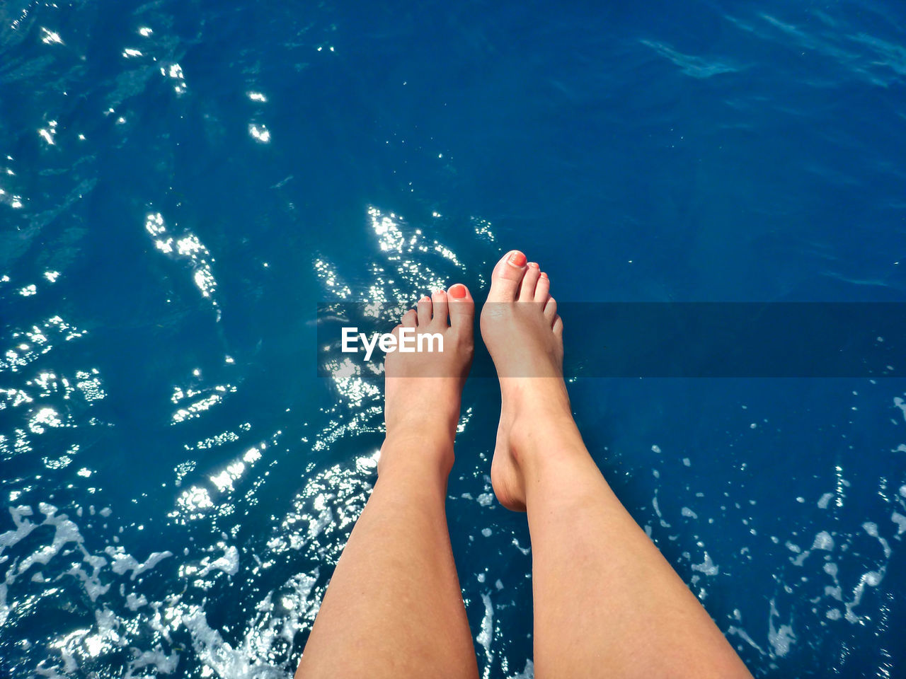 Low section of woman feet above the ocean